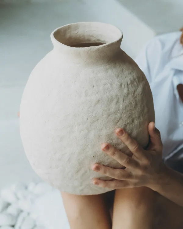 Women holding vase