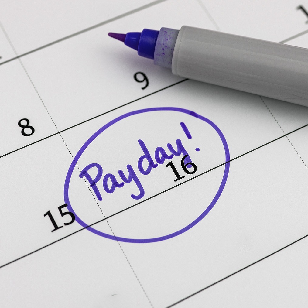 Calendar with the 16th circled in purple marker and labeled "Payday!" for payroll scheduling