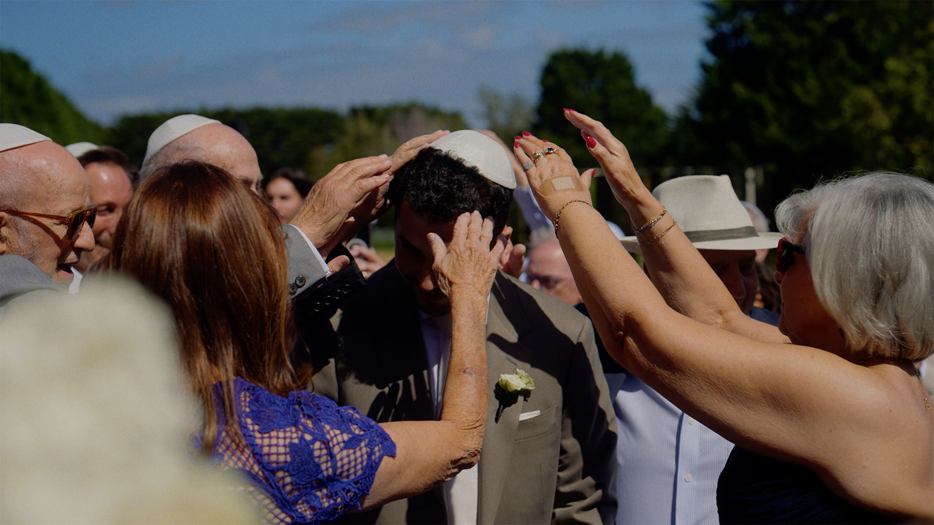 Groom receiving a blessing from his family during the bedeken