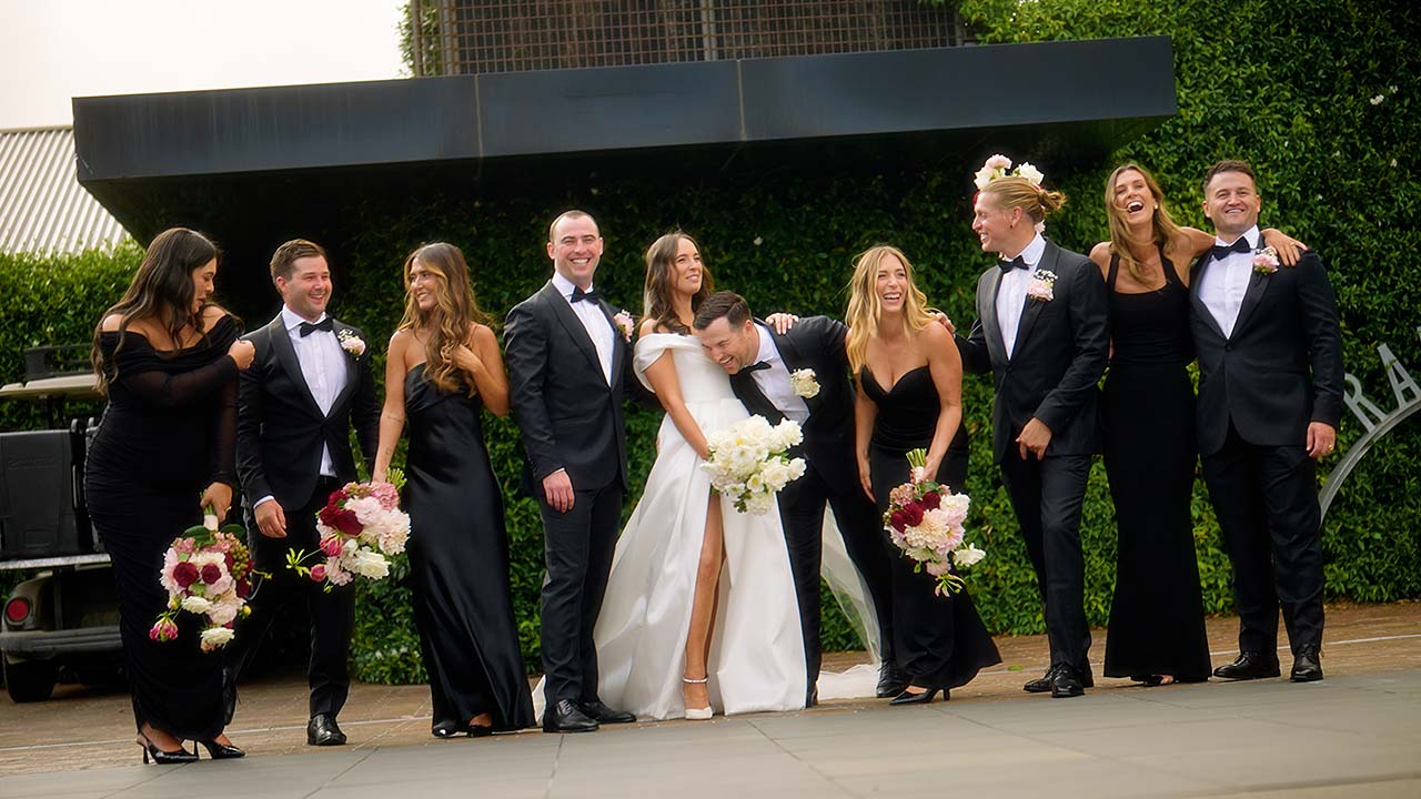bridal party together laughing and having a good time during wedding photos