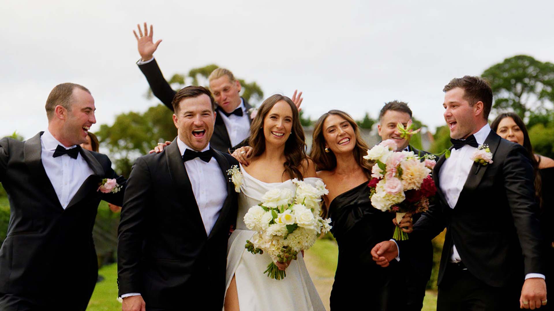 bridal party sharing a moment together at wedding