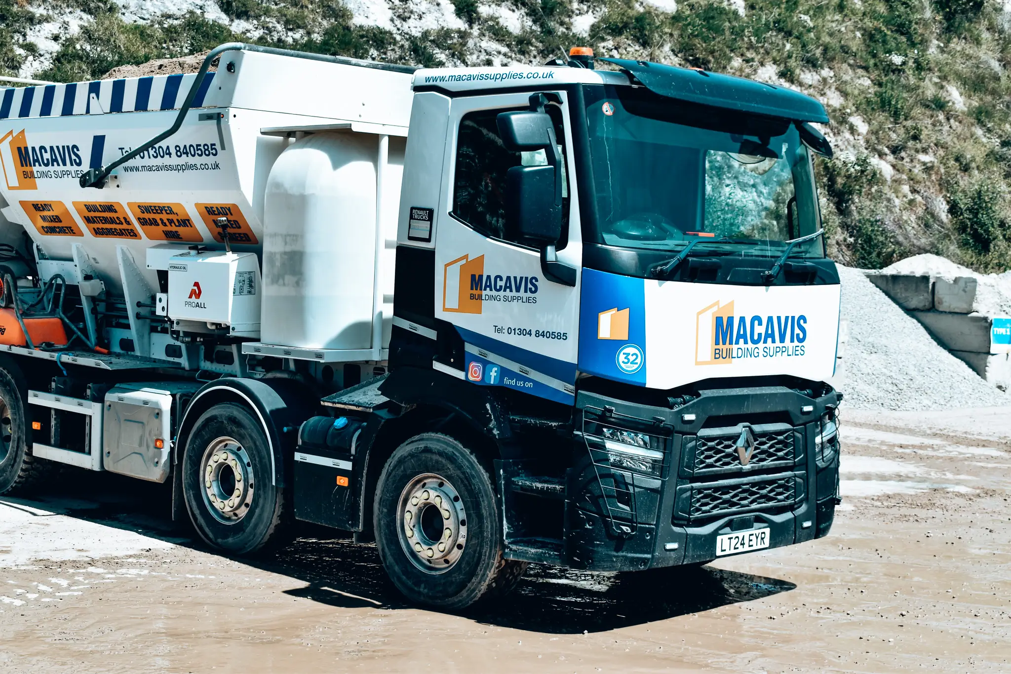 Macavis Building Supplies truck parked on a snowy construction site