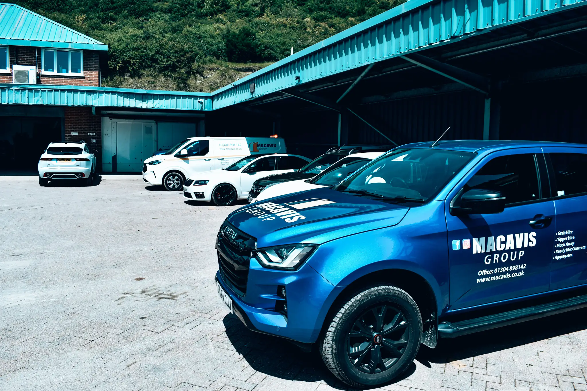 Blue Macavis Group vehicle fleet parked at company headquarters
