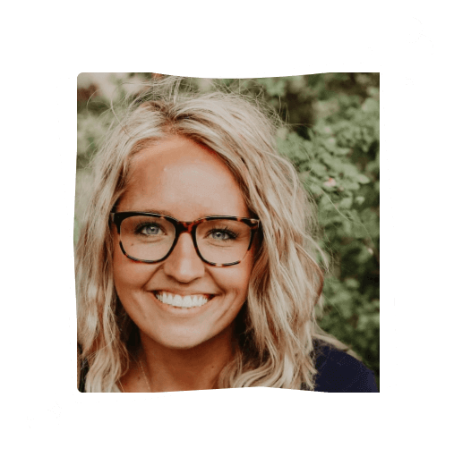 Portrait of a smiling woman with wavy blonde hair and glasses against a leafy green background. The image has a playful black and white border with doodles.