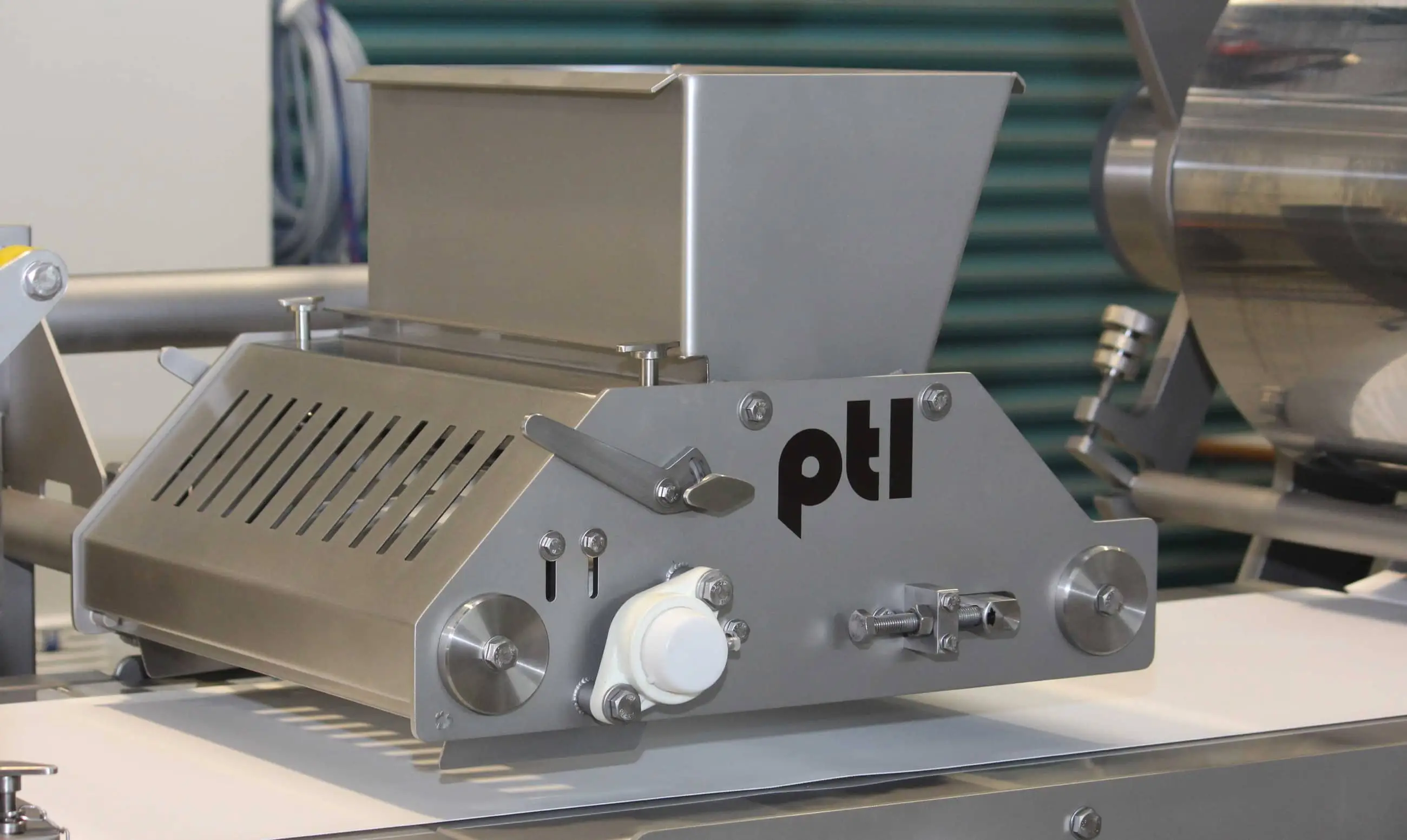 A silver machine with the letters PTL on it.