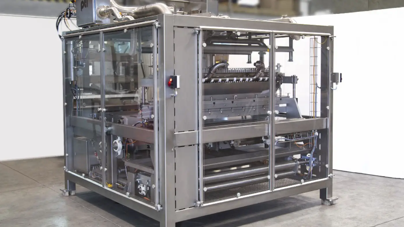 Industrial machine with metal frame and glass safety panels