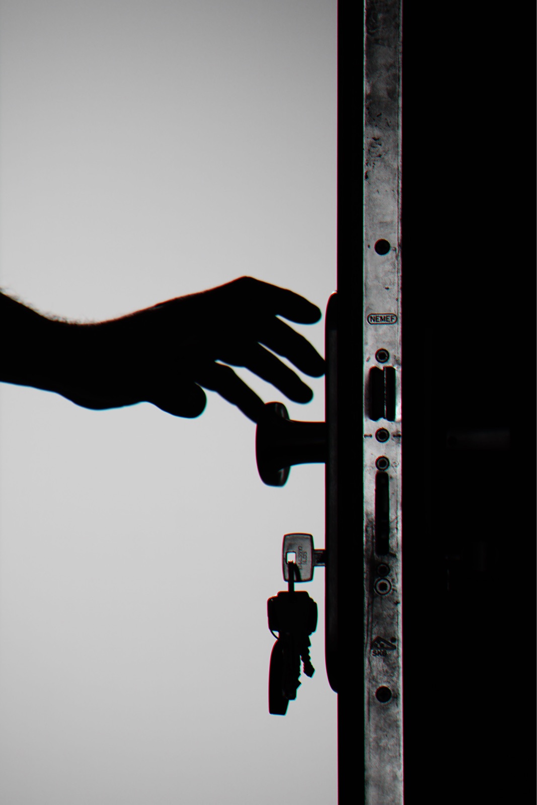 Hand reaching for a locked front door handle