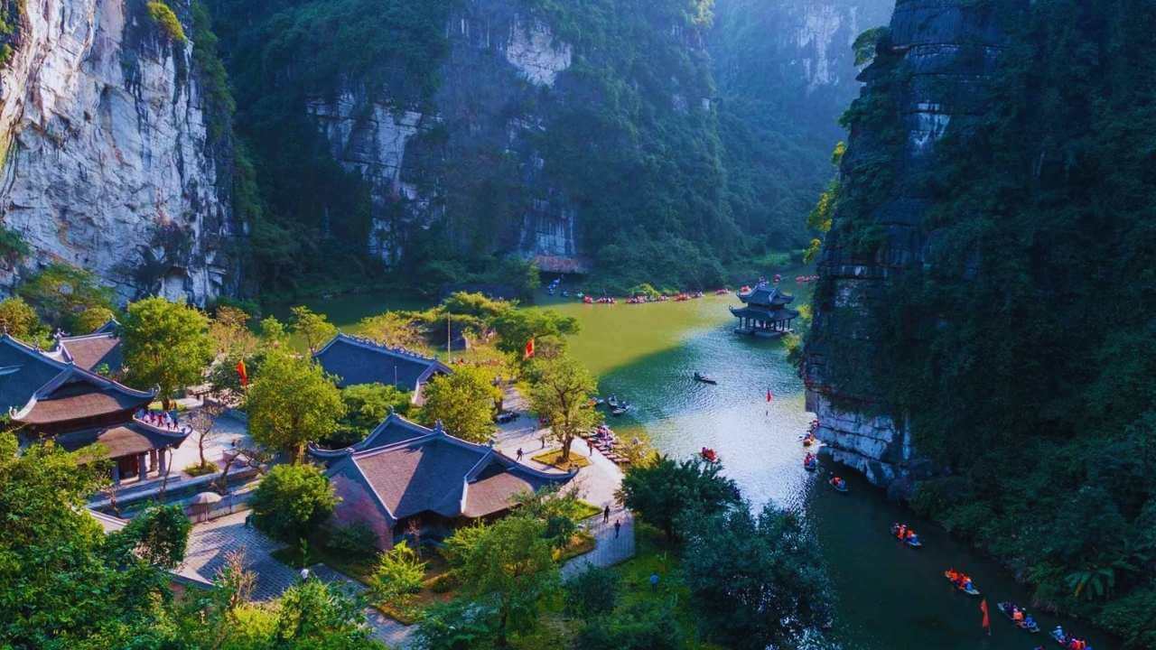 The Trang An boat tour wharf in Ninh Binh, surrounded by towering karst mountains.