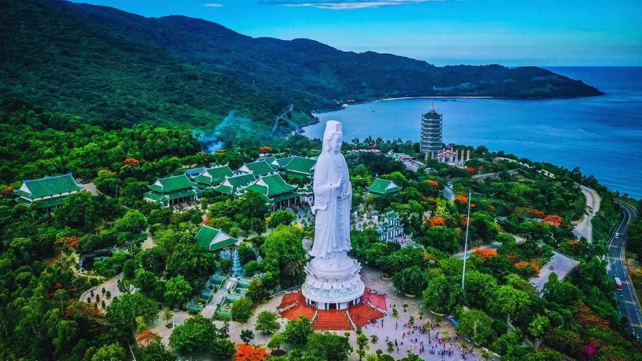 The white Lady Buddha statue at Linh Ung Pagoda on Son Tra Peninsula, overlooking the sea.