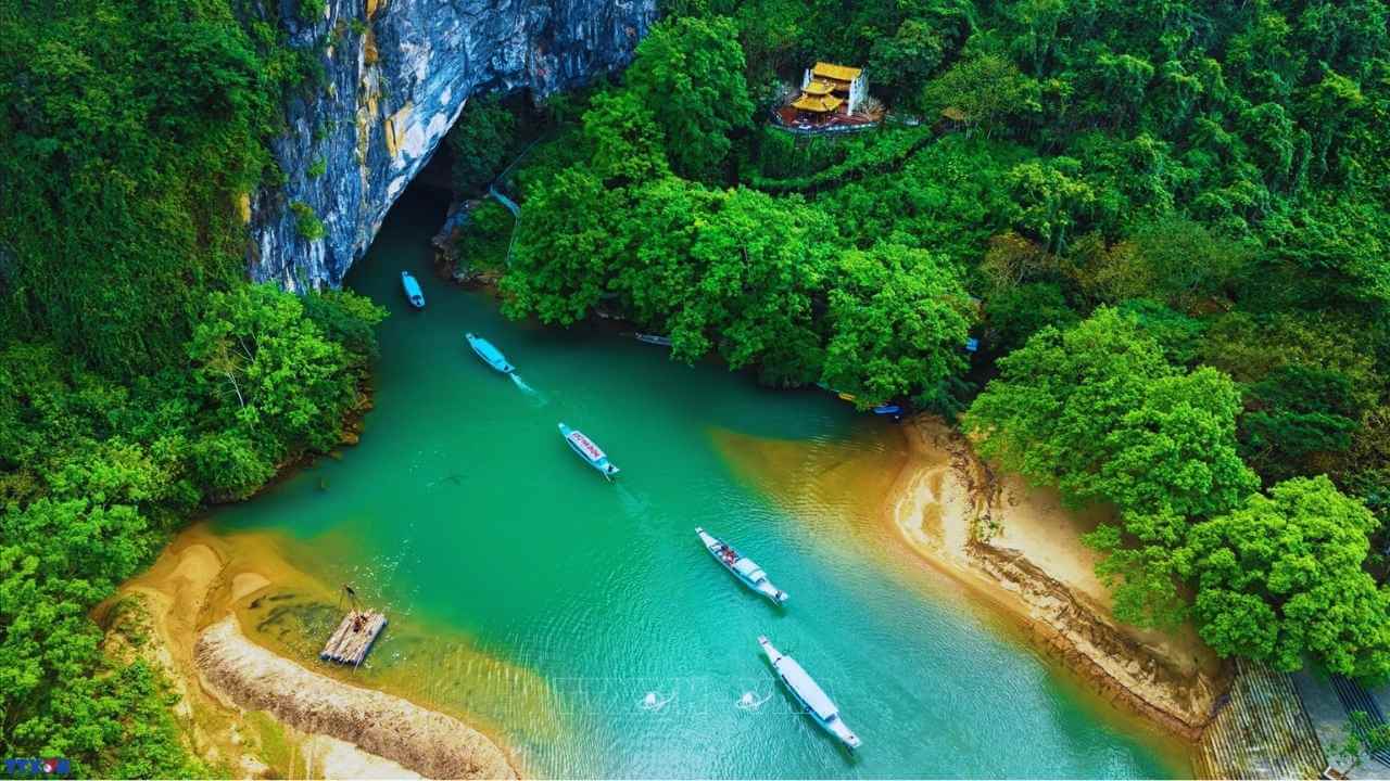 Aerial view of a boat trip on the emerald river leading into Phong Nha Cave, Quang Binh.