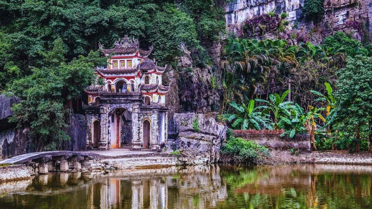 Stone bridge leading to the ancient Bich Dong Pagoda, a popular Tam Coc attraction.