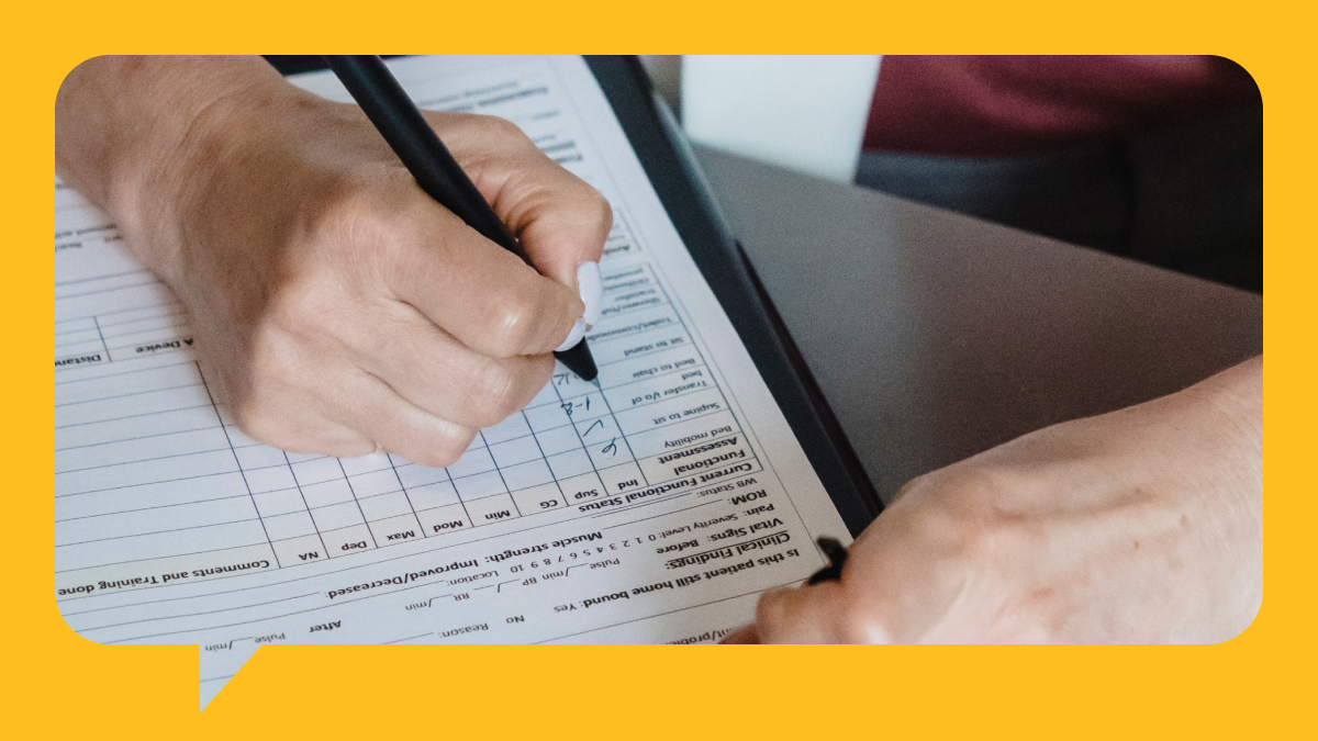 Close up shot of an individual filling out a patient information form