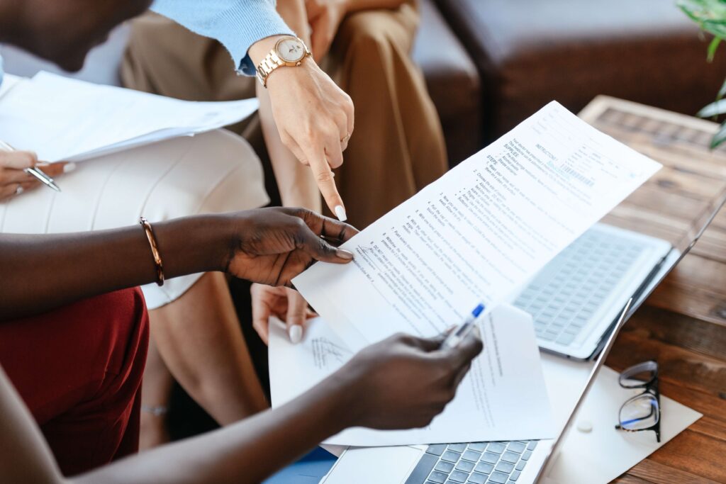 Close up of team members reviewing a checklist for HITRUST assessments