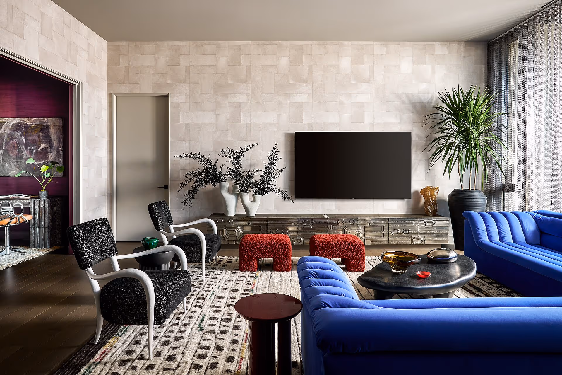 Interior renovation of living room with amazing blue couch and chairs pointing to a TV