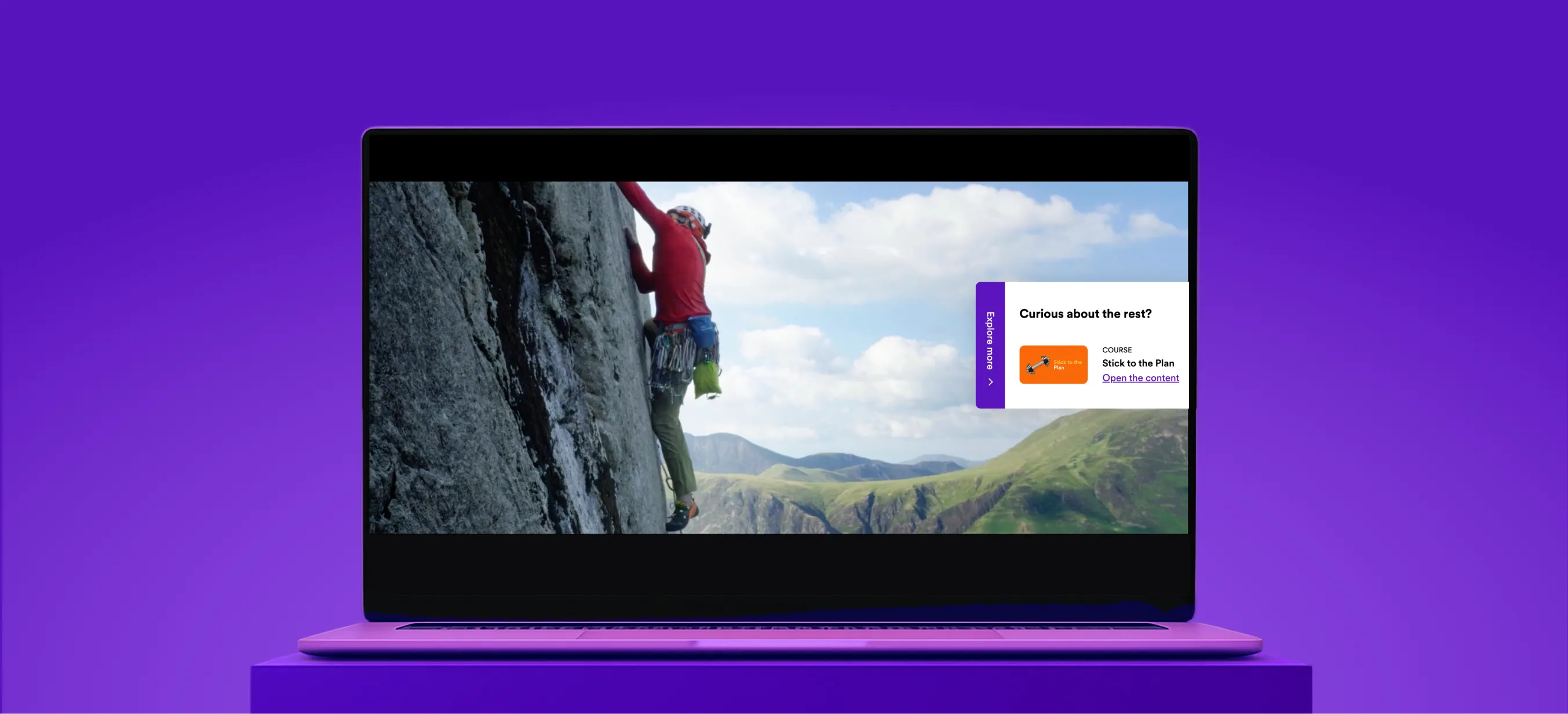 A laptop on a purple platform displaying a GoodHabitz activity screen, with a video of a person rock climbing and an interactive course suggestion overlay, illustrating the range of activities available on the GoodHabitz learning platform.
