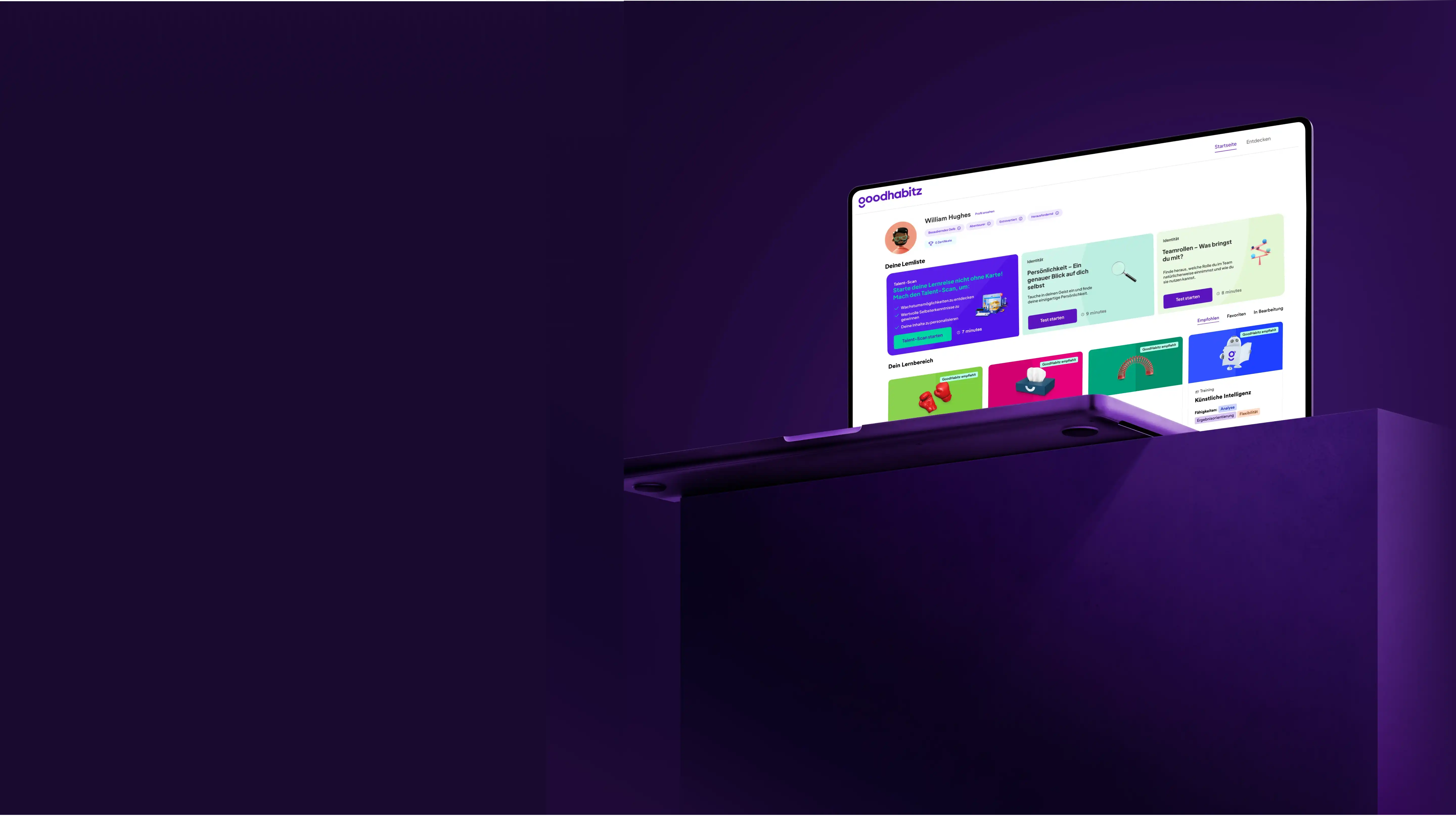 Laptop displaying a user profile and learning modules on the goodhabitz platform, placed on a dark purple pedestal against a purple background.
