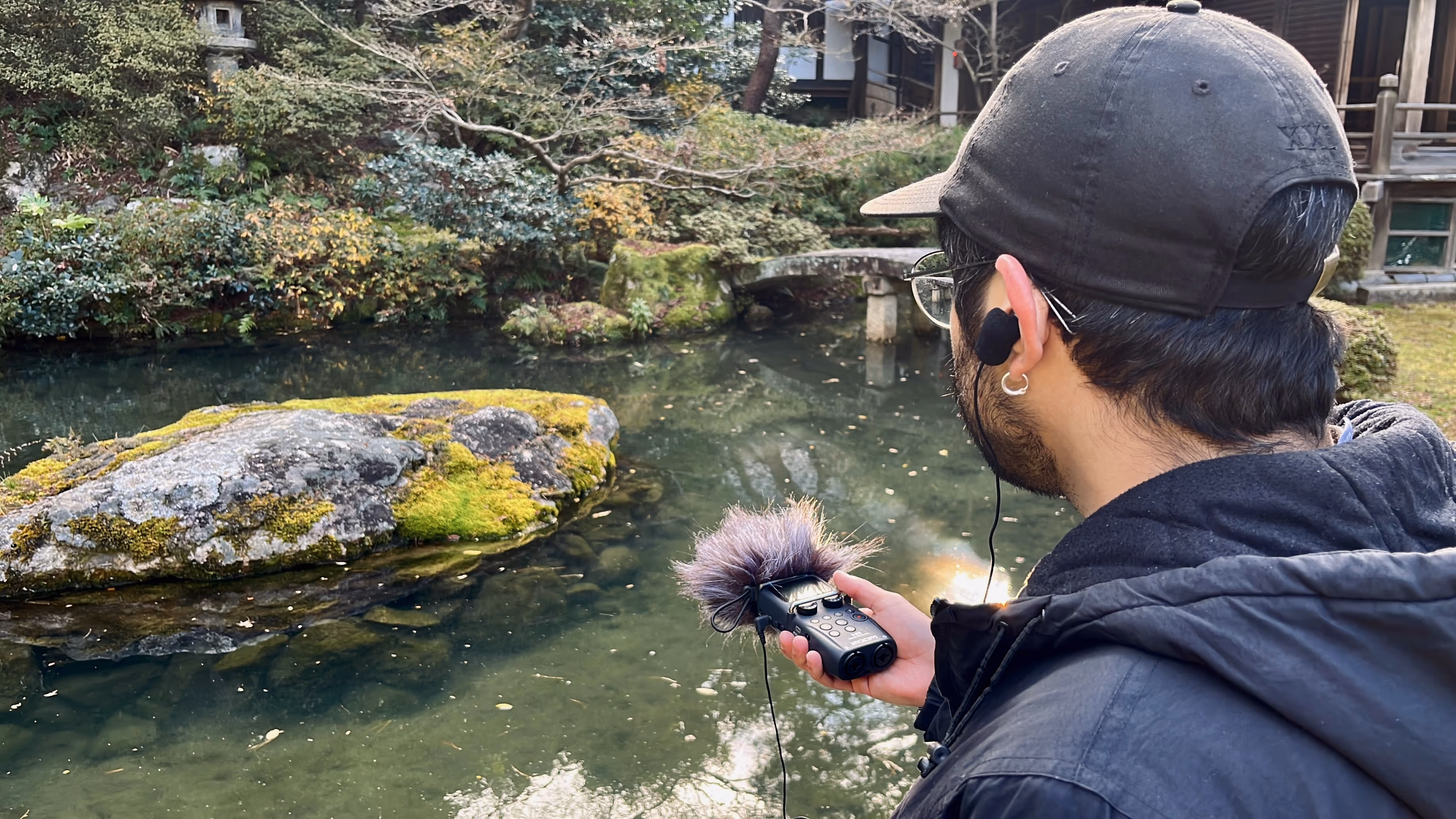 A guest on a Sound Walk recording the peaceful sound of the tranquil Japanese Pond at Shoren-in Temple.