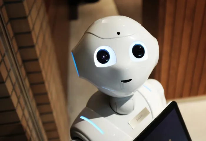 White Robot Near Brown Wall