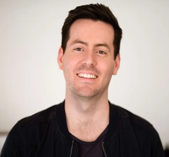 A Man Smiling For The Camera