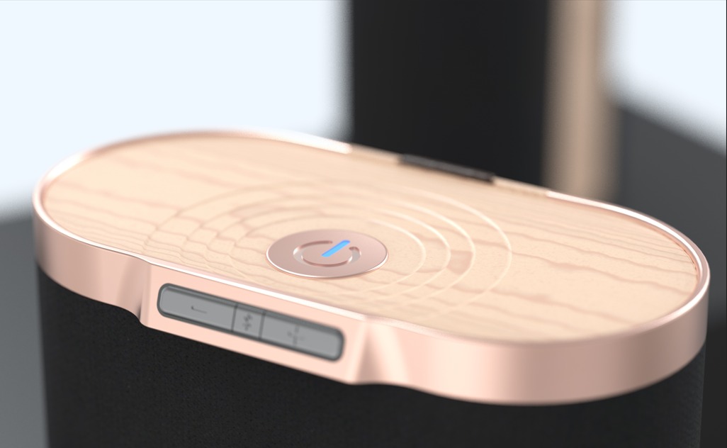 Close-up rendering of a compact black device with a wood-patterned top, rose-gold trim, and illuminated power button.