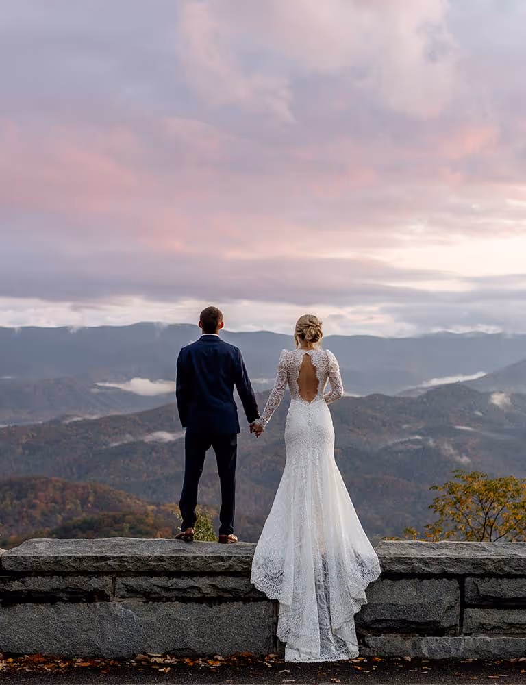 A photo of a couple on the famous stone wall at Foothills Parkway.