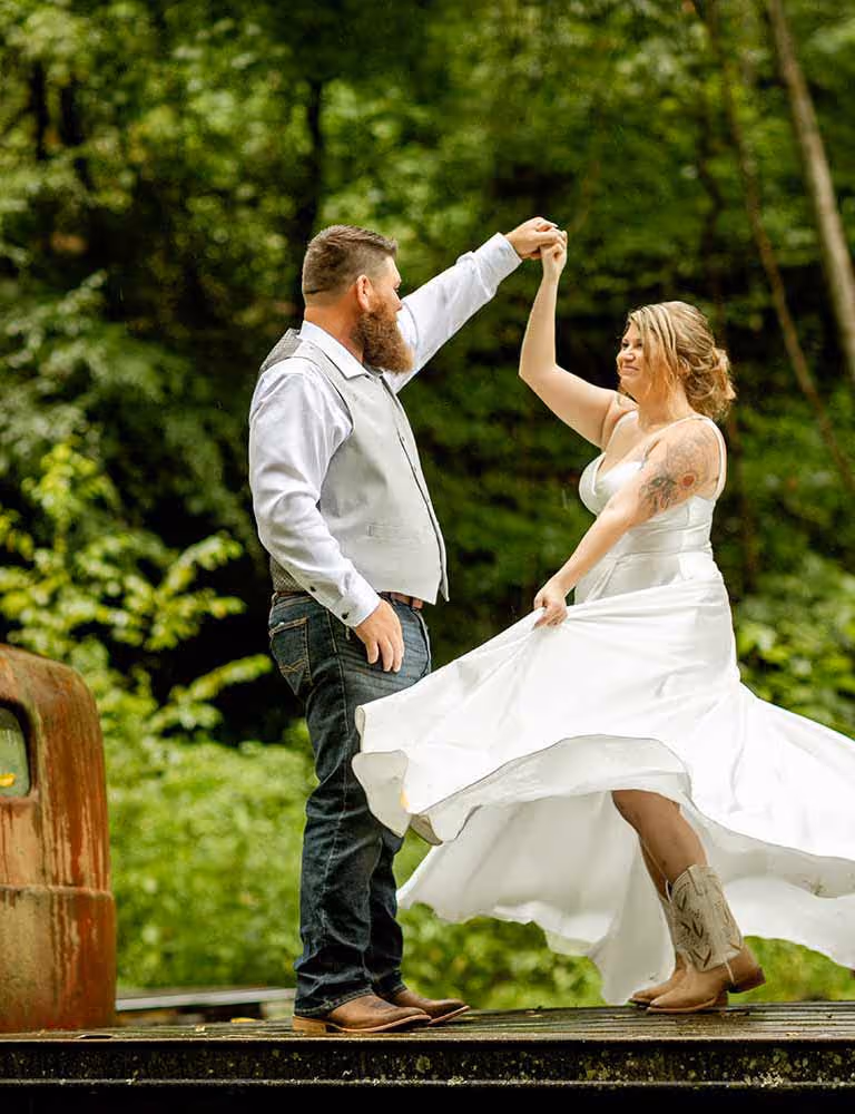 A newlywed couple dancing at Elly's Mill on an old truck bed.