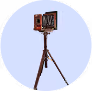 Vintage wooden stereoscope on a tripod stand against a white background.