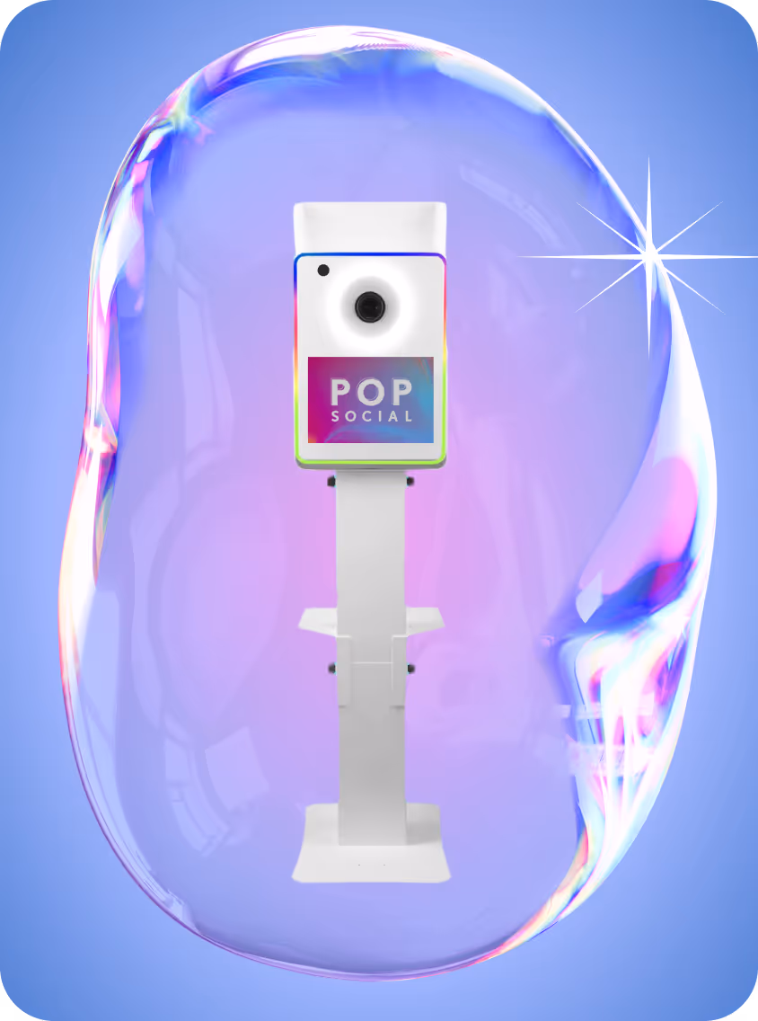 White photo booth kiosk with 'POP SOCIAL' logo encased inside a large iridescent bubble on a blue background.