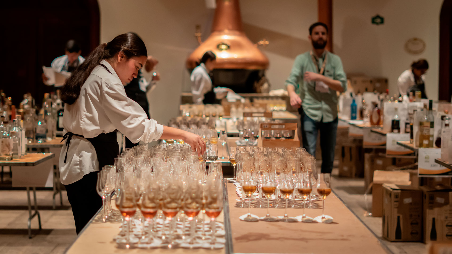 View of the preparation room at Spirits Selection 2025 in Tequila, where rows of glasses filled with spirits samples are organized and ready for tasting.