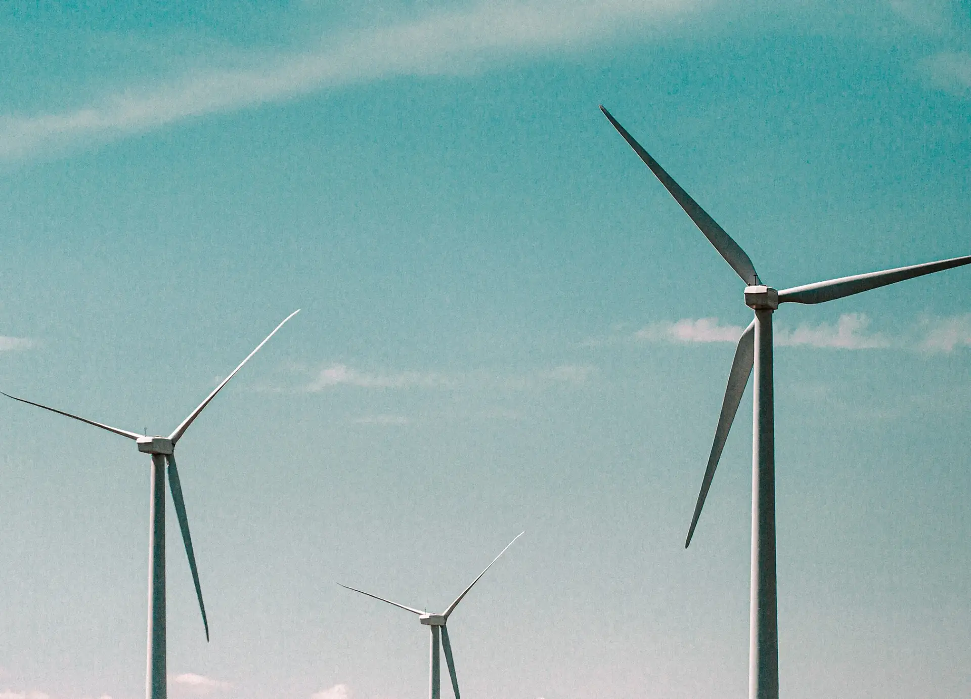 Wind turbines against a clear sky, representing renewable energy