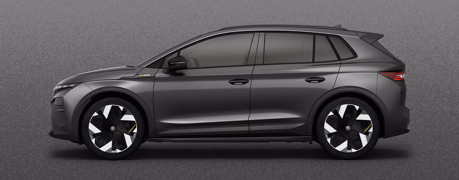 Seitenansicht eines Škoda Elroq in der Farbe Graphite-Grau Metallic mit 20 Zoll Leichtmetallfelgen “Vega” vor einem einfarbigen Hintergrund im Farbton der Fahrzeuglackierung.