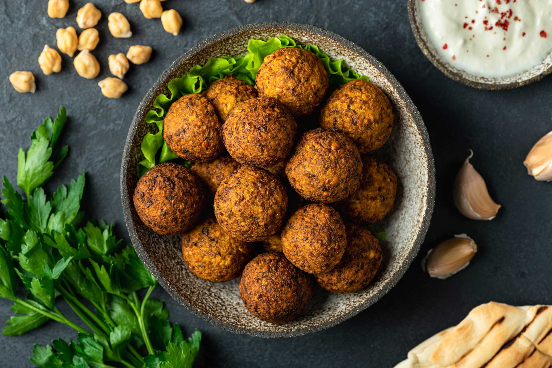 A bowl of meatballs with a spoon in it.