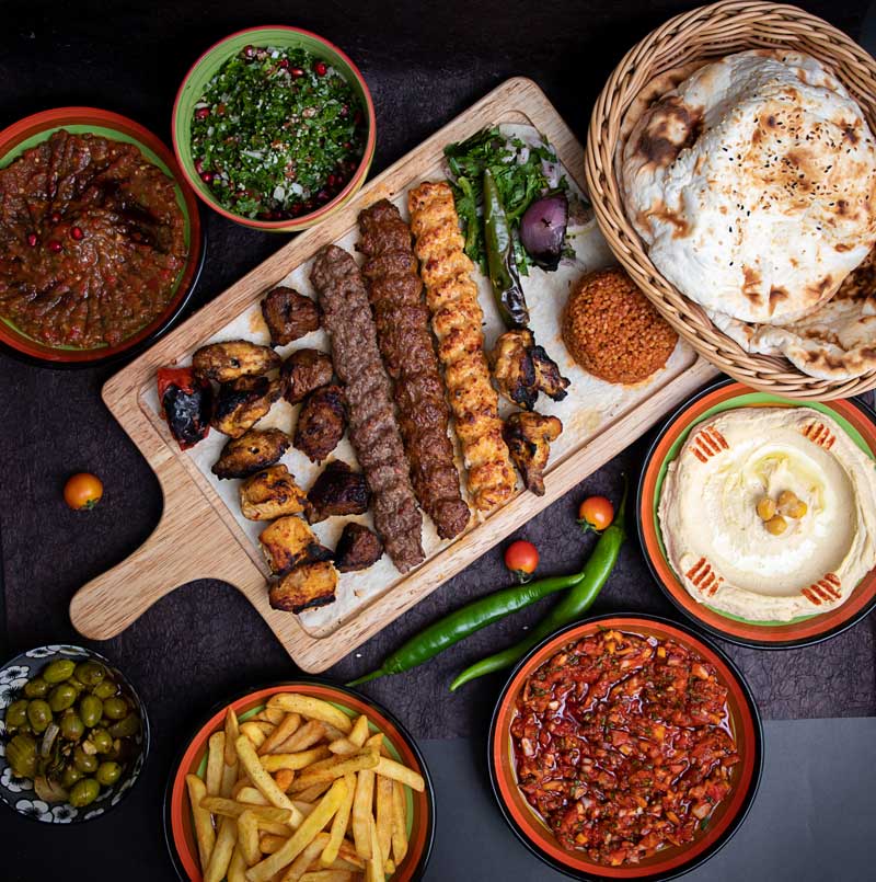 A wooden cutting board with a variety of foods on it.