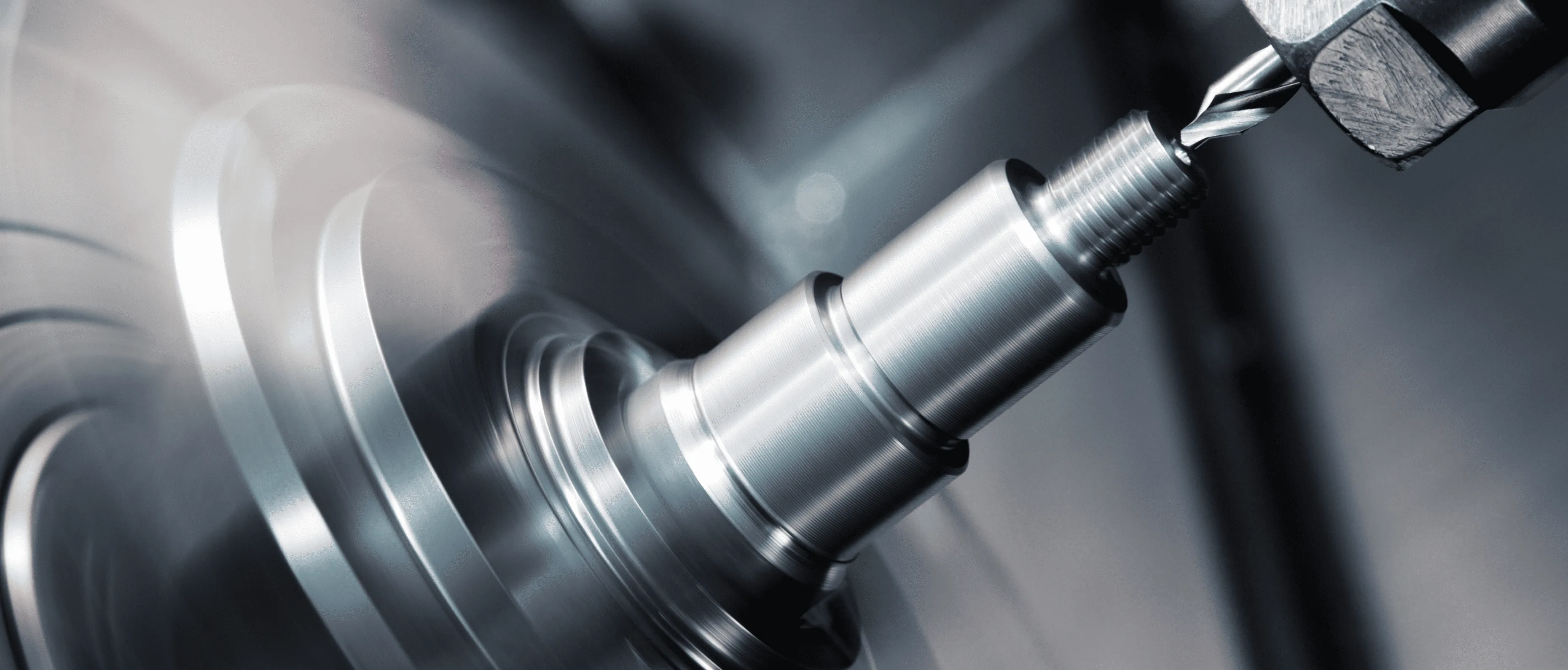 A silver metal bolt in a machine. - Forgent Images