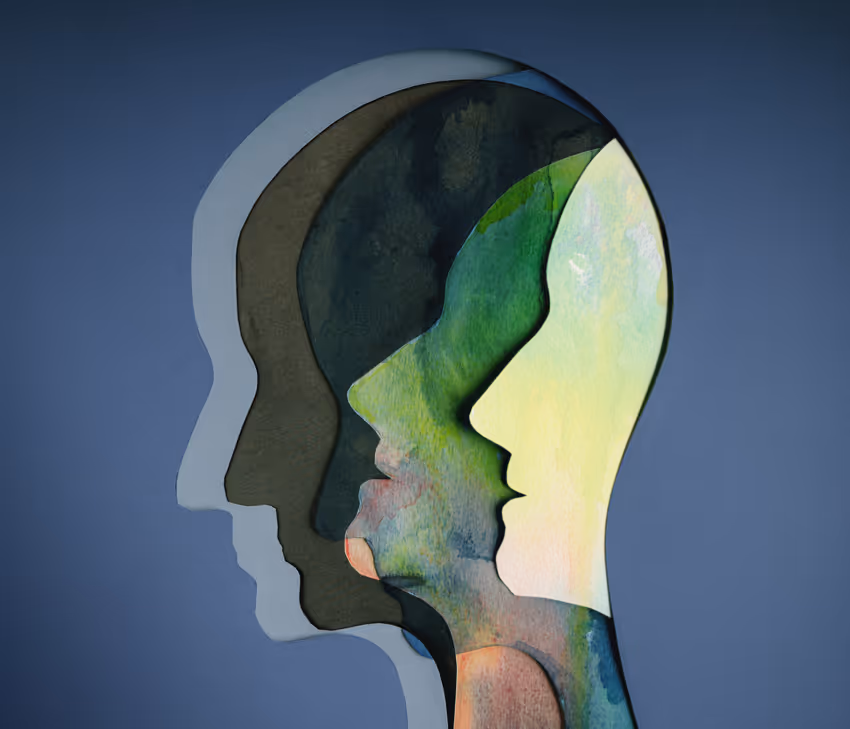 a group of people's faces cut out of paper