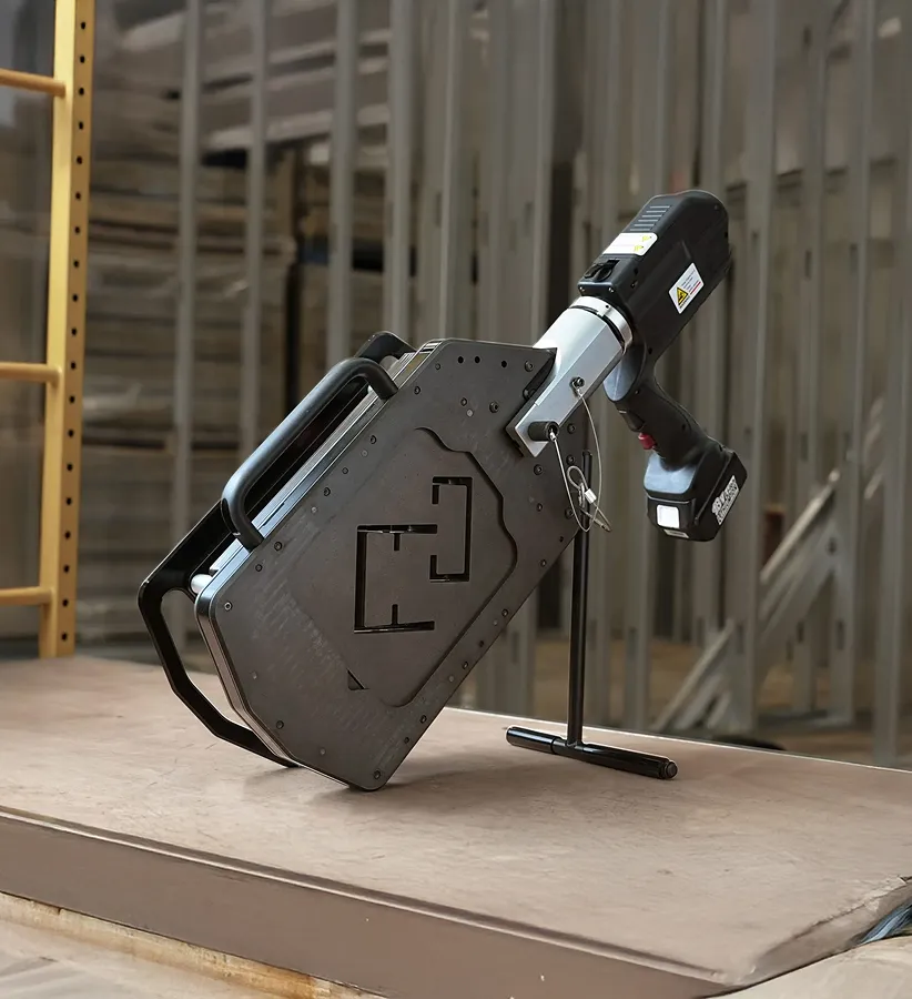 Close-up of a precision industrial machine part with safety warning labels and red laser guides.