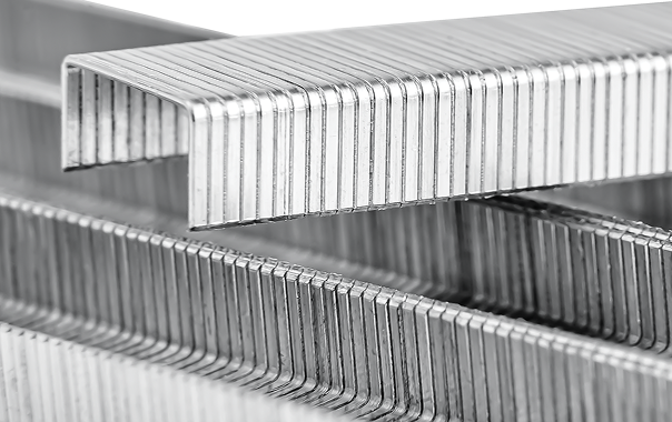 Close-up view of several stacked silver metal staples.
