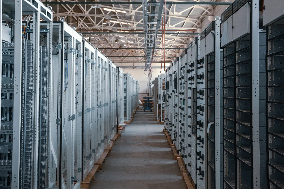 Long aisle of electrical cabinets inside a data center under construction