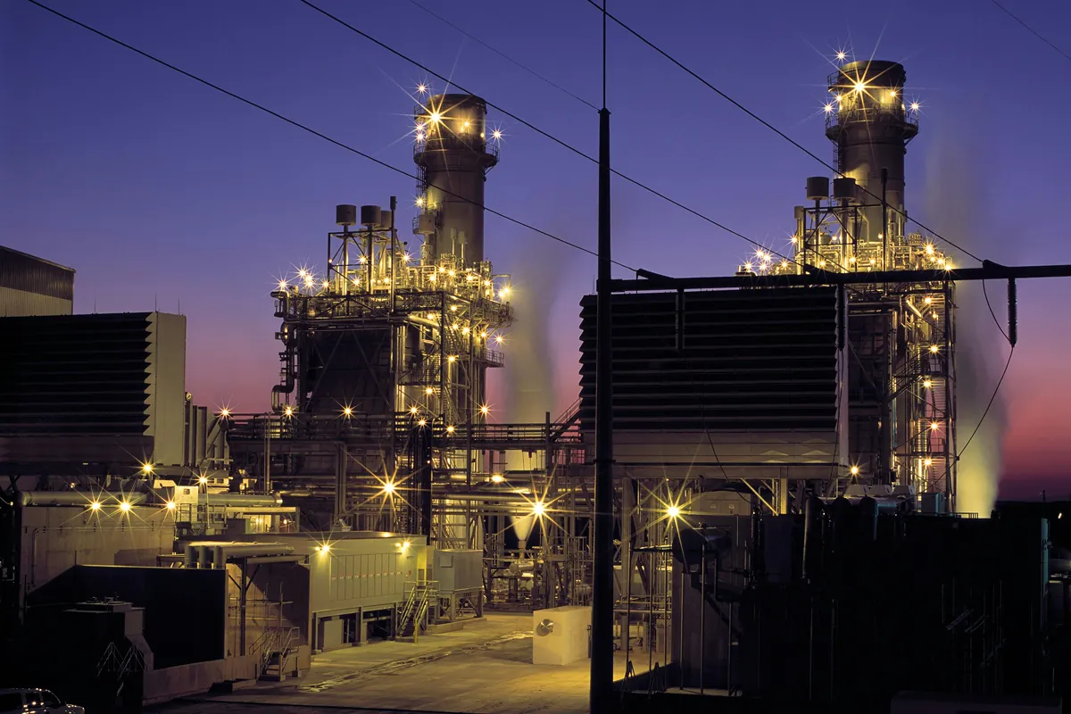 Power plant with lit exhaust stacks at dusk