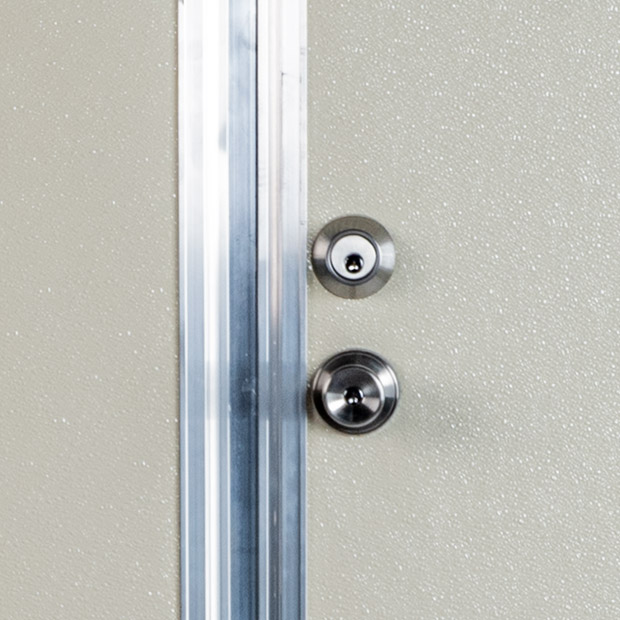 Close-up on knob and deadbolt on Utility Door