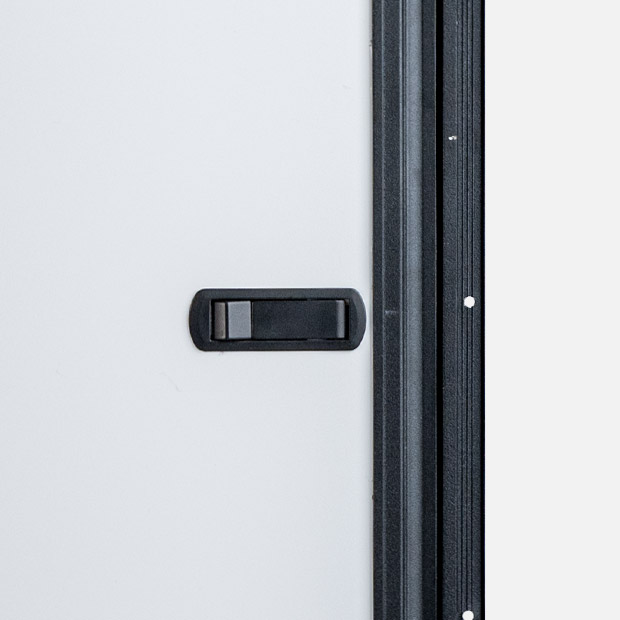 Close-up of push-button latch on Cabinet Door