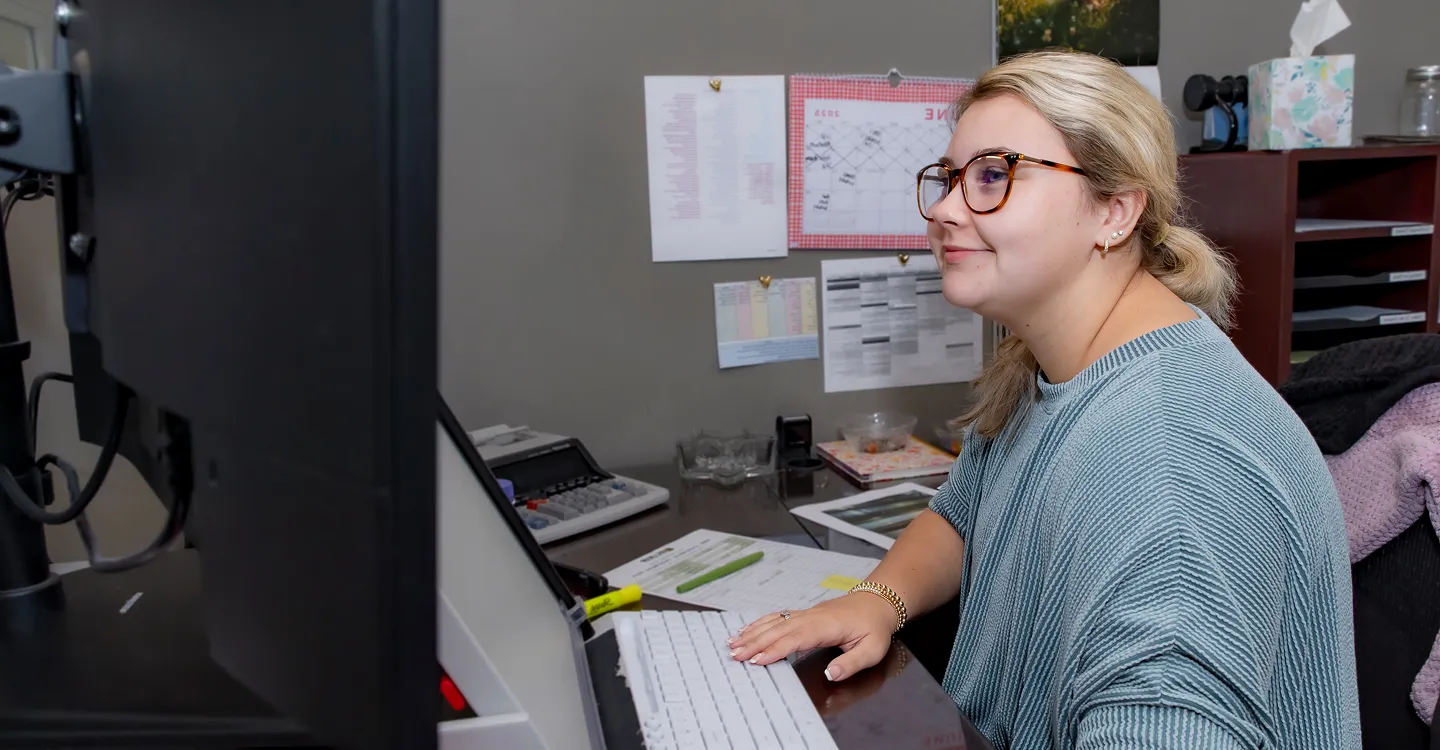 Office worker typing at a computer desk
