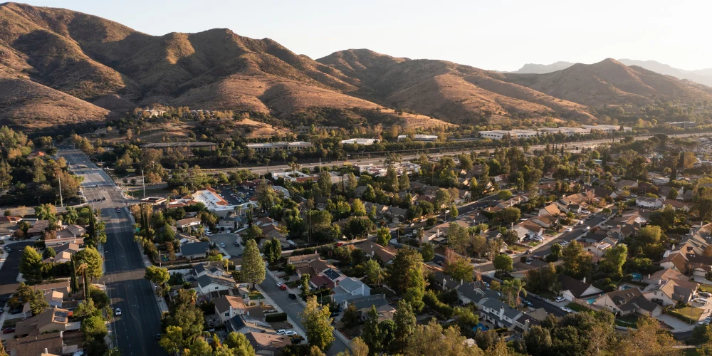 Aerial view of Agoura Hills neighborhoods surrounded by trees and foothills