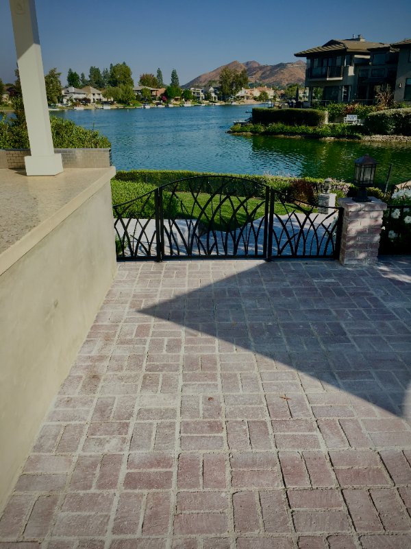 Elegant Backyard Hardscape with Lake Views Near Westlake by Jessie Flores Landscape Co. in Thousand Oaks, CA
