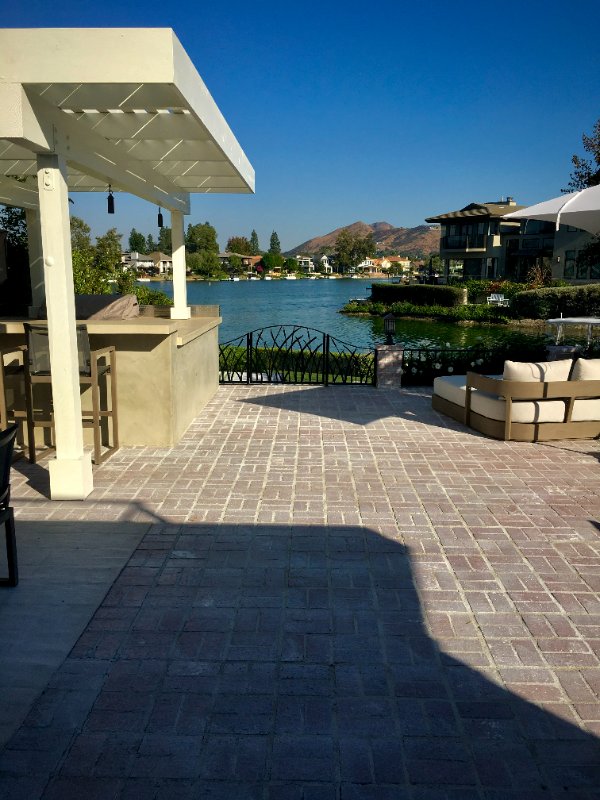Custom Hardscape Backyard Design Overlooking Westlake Lake by Jessie Flores Landscape Co. in Thousand Oaks, CA