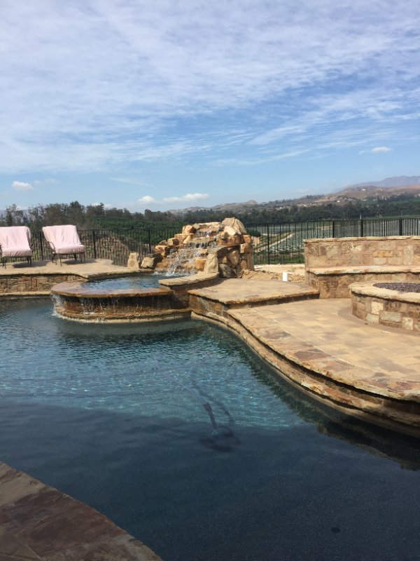 Scenic Pool with Stone Hardscape and Panoramic View by Jessie Flores Landscape Co. in Thousand Oaks, CA