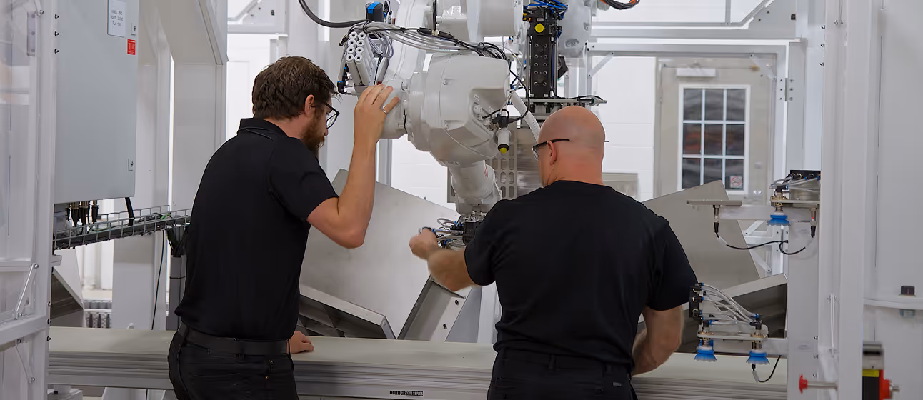 Convergix employees working on machinery.