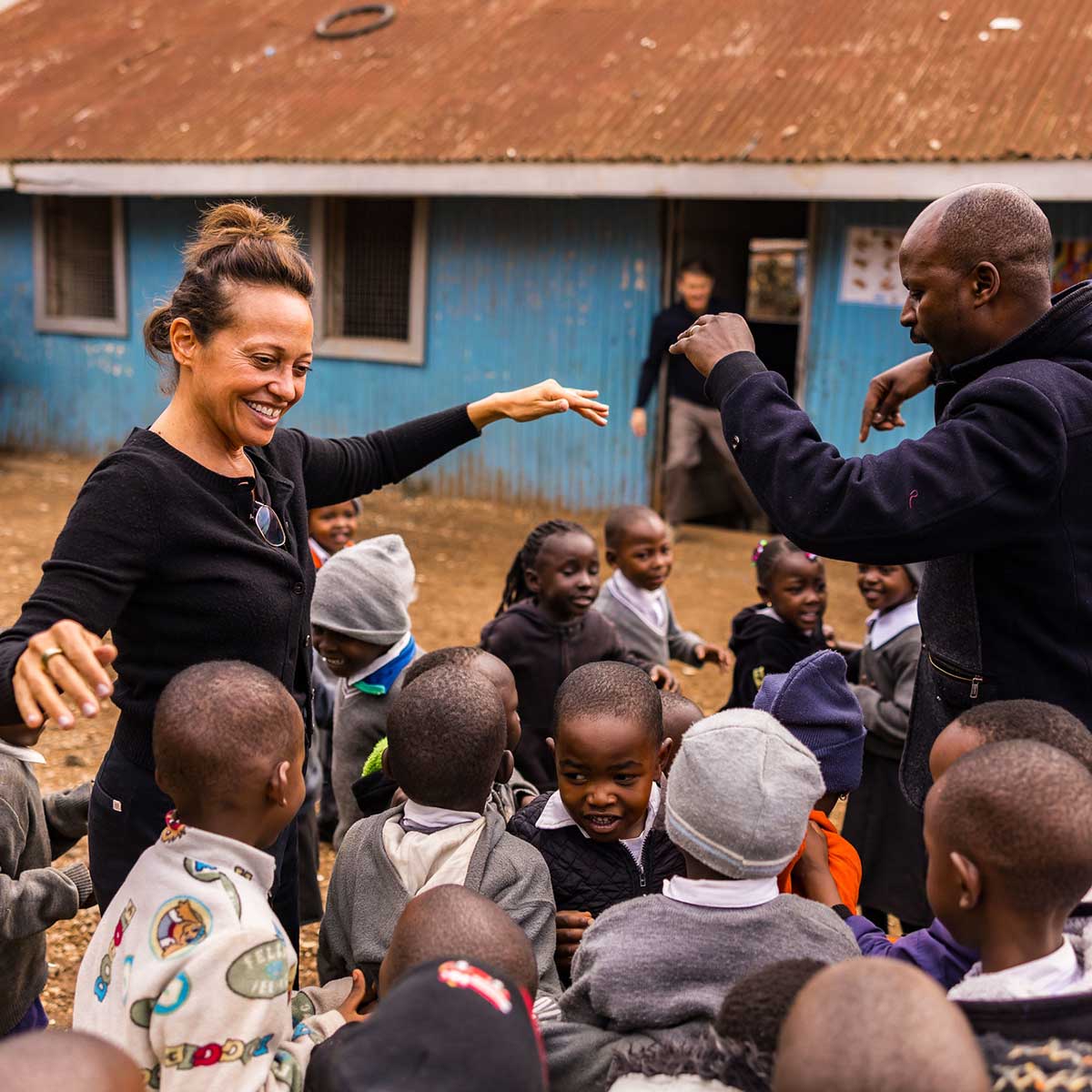 Wendy Palau smiling around young children