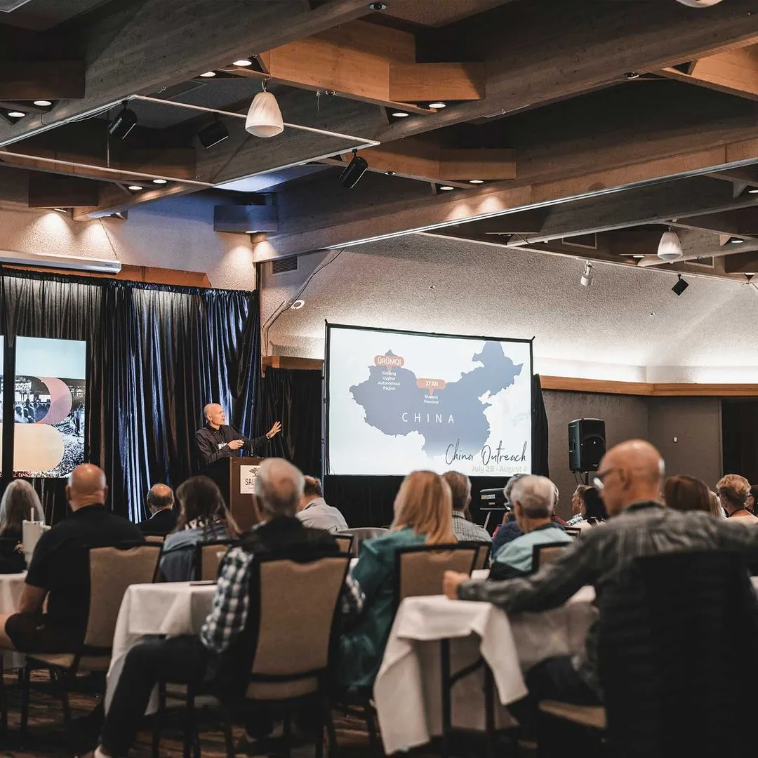 Kevin Palau on stage speaking to an audience of people