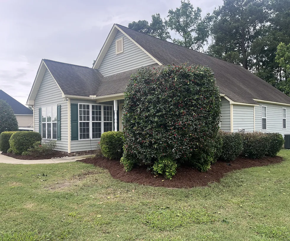 The exterior of a home with a lawn that has been landscaped